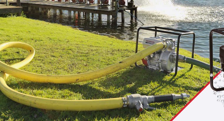 Honda water pump moving water at a lakeside